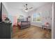 Well-lit bedroom featuring a crib, hardwood floors, and large window at 11707 Se 101St Court Rd, Belleview, FL 34420
