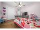 Cozy bedroom with hardwood floors, closet, and a ceiling fan at 11707 Se 101St Court Rd, Belleview, FL 34420