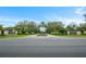 Beautiful community entrance with manicured landscaping, decorative lighting, and a central water feature at 11707 Se 101St Court Rd, Belleview, FL 34420