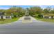 Inviting community entrance with elegant signage, landscaping, and a charming water feature at 11707 Se 101St Court Rd, Belleview, FL 34420