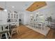 Dining room featuring a white table with seating for eight and decorative chandeliers at 11707 Se 101St Court Rd, Belleview, FL 34420
