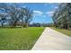 Picturesque property featuring a long driveway leading to a well-maintained home at 11707 Se 101St Court Rd, Belleview, FL 34420
