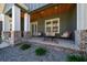 Charming front porch with brick accents and cozy outdoor seating at 11707 Se 101St Court Rd, Belleview, FL 34420