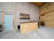Unfinished garage interior with wood walls and a small bar area, ready for customization and personalization at 11707 Se 101St Court Rd, Belleview, FL 34420