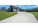 Spacious two-car garage with a long driveway, set in a serene landscape at 11707 Se 101St Court Rd, Belleview, FL 34420