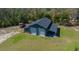 Large detached garage with roll-up doors and covered patio at 11707 Se 101St Court Rd, Belleview, FL 34420