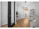 Hallway leading to the dining room with hardwood floors and decorative lighting at 11707 Se 101St Court Rd, Belleview, FL 34420