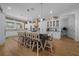 Kitchen featuring a large island with bar seating, white cabinets, and modern appliances at 11707 Se 101St Court Rd, Belleview, FL 34420