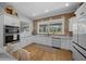 Modern kitchen with stainless steel appliances, white cabinetry and a wooden accent wall at 11707 Se 101St Court Rd, Belleview, FL 34420