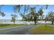 Picturesque lake view featuring a dock and boat ramp surrounded by mature trees and Spanish moss at 11707 Se 101St Court Rd, Belleview, FL 34420