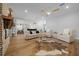 Bright, open-concept living space with hardwood floors and seamless access to the kitchen at 11707 Se 101St Court Rd, Belleview, FL 34420