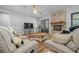 Cozy living room boasts hardwood floors, fireplace and comfortable seating at 11707 Se 101St Court Rd, Belleview, FL 34420