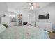 Open Primary bedroom with a ceiling fan, hardwood floors, and an attached bathroom at 11707 Se 101St Court Rd, Belleview, FL 34420