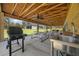 Spacious covered patio with an outdoor kitchen, grill, and picnic tables, perfect for entertainment at 11707 Se 101St Court Rd, Belleview, FL 34420