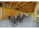 Covered outdoor patio with ceiling fans, dining table, and wood paneled walls perfect for gatherings at 11707 Se 101St Court Rd, Belleview, FL 34420