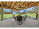 Covered outdoor patio featuring a ceiling fan and a comfortable seating area with backyard views at 11707 Se 101St Court Rd, Belleview, FL 34420