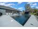 A beautiful triangle-shaped pool with a built-in bar and lounge chairs creates a relaxing backyard retreat at 11707 Se 101St Court Rd, Belleview, FL 34420