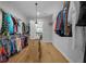 Well-organized walk-in closet featuring ample shelving and hanging space for clothes and accessories at 11707 Se 101St Court Rd, Belleview, FL 34420