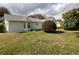 A spacious green backyard featuring drought-resistant landscaping surrounds the home at 14191 Sw 115Th Ter, Dunnellon, FL 34432