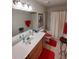Traditional bathroom featuring a white countertop, cherry cabinets, and bright red accents at 14191 Sw 115Th Ter, Dunnellon, FL 34432