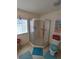 Bathroom featuring a glass-enclosed shower, tile flooring, and ample natural light at 14191 Sw 115Th Ter, Dunnellon, FL 34432