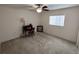 Neutral bedroom with window, desk, and ceiling fan, perfect for relaxation or study at 14191 Sw 115Th Ter, Dunnellon, FL 34432