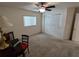 Neutral bedroom with window, closet, desk, and ceiling fan, perfect for relaxation or study at 14191 Sw 115Th Ter, Dunnellon, FL 34432