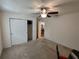 Neutral bedroom with window, closet, and ceiling fan, perfect for relaxation at 14191 Sw 115Th Ter, Dunnellon, FL 34432