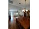 Open-concept dining room with hardwood floors, chandelier, and view of living room at 14191 Sw 115Th Ter, Dunnellon, FL 34432