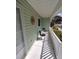 Comfortable and shady front porch area with two chairs and a small table at 14191 Sw 115Th Ter, Dunnellon, FL 34432