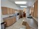 Spacious kitchen with light cabinets, tile floors, and ample countertop space at 14191 Sw 115Th Ter, Dunnellon, FL 34432