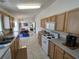 Open kitchen with tile floors, light cabinets, seamlessly connecting to a bright dining area at 14191 Sw 115Th Ter, Dunnellon, FL 34432