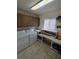 Functional laundry room with washer, dryer, built-in cabinets, and folding area at 14191 Sw 115Th Ter, Dunnellon, FL 34432