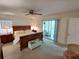 Spacious main bedroom with a ceiling fan, cozy furnishings, and access to the outdoors at 14191 Sw 115Th Ter, Dunnellon, FL 34432