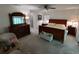 Inviting main bedroom featuring a ceiling fan, neutral walls, and comfortable furniture at 14191 Sw 115Th Ter, Dunnellon, FL 34432