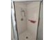 Bright stand-up shower featuring a silver shower head, safety bar, and white tiling at 14191 Sw 115Th Ter, Dunnellon, FL 34432
