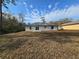 View of the home's back exterior with a large yard at 15 Locust Trak, Ocala, FL 34472