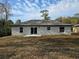 Back exterior featuring a sliding glass door that leads to the backyard at 15 Locust Trak, Ocala, FL 34472