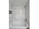 A white tiled tub-shower combo with black accent tile in a built-in niche, and modern fixtures at 15 Locust Trak, Ocala, FL 34472