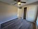 Neutral bedroom featuring wood-look flooring, a ceiling fan, closet and neutral paint at 15 Locust Trak, Ocala, FL 34472
