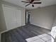 Bedroom with gray walls, gray wood-look floors, and a large closet at 15 Locust Trak, Ocala, FL 34472