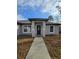 View of the front entrance and walkway leading to the front door of a well maintained home at 15 Locust Trak, Ocala, FL 34472