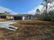 Beautiful single-story home with a black garage door and a well-manicured lawn at 15 Locust Trak, Ocala, FL 34472