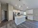 Stylish kitchen with white cabinets, quartz countertops, stainless steel appliances, and a functional center island at 15 Locust Trak, Ocala, FL 34472