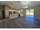 Modern kitchen and dining area featuring stainless steel appliances, white cabinets, and a center island at 15 Locust Trak, Ocala, FL 34472