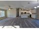 Open floorplan with a spacious living room and kitchen featuring gray wood-look floors at 15 Locust Trak, Ocala, FL 34472