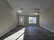 Bright living room with wood flooring, ceiling fan, and natural light streaming through the windows at 15 Locust Trak, Ocala, FL 34472