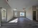 Bright living room with wood flooring, ceiling fan, and natural light streaming through the windows at 15 Locust Trak, Ocala, FL 34472