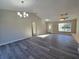 Spacious living room with vaulted ceiling, ceiling fan, and modern gray flooring at 15 Locust Trak, Ocala, FL 34472