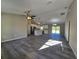 Spacious living room with hardwood floors, neutral paint, a ceiling fan, and a combined kitchen and dining area at 15 Locust Trak, Ocala, FL 34472